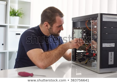 Stock photo: Young It Professional Fixing Computer Problem