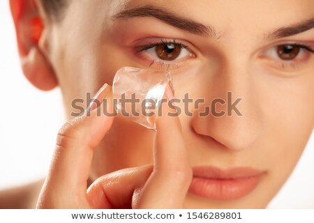 Foto stock: Woman Holding Ice Cube On Her Face