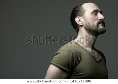 Portrait Of A Handsome Muscular Man Standing Over Gray Background Сток-фото © Augustino