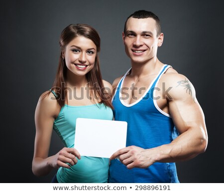 Man With Athletic Muscular Body Holding Blank Notice Board Stok fotoğraf © restyler