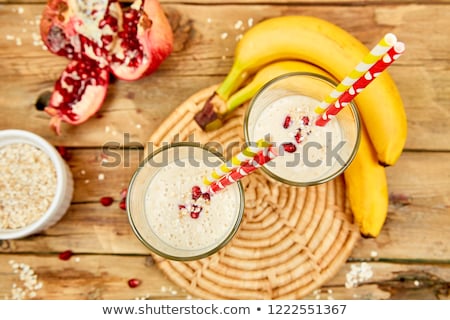 Stock fotó: Smoothie With Oat Or Oatmeal Banana And Pomegranate On Wooden Rustic Background