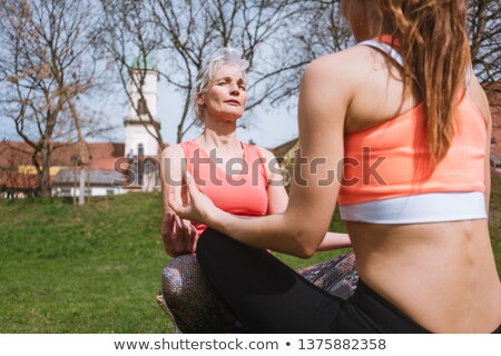 Stock foto: Mother And Adult Daughter In Yoga Mediation Outdoors