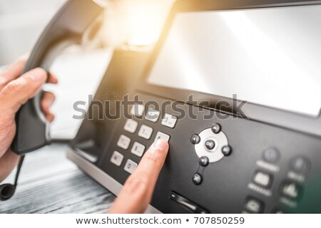 Stock photo: Office Assistant Dialing Phone Number