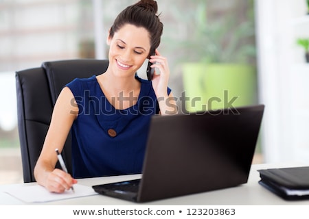 Foto d'archivio: Happy Businesswoman Talking On The Cellphone And Writing In Orga