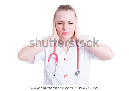 Foto d'archivio: Young Beautiful Frustrated Female Doctor Covering Ears With Her Hands As Need Of Silence Concept On