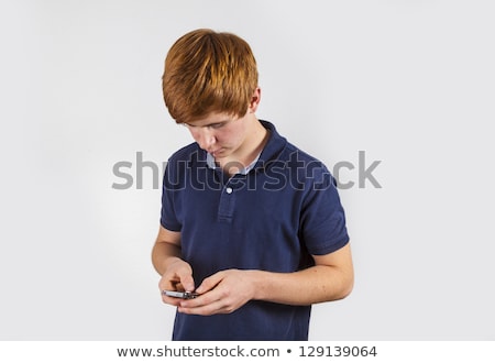 Stock photo: Cute Handsome Boy Dialing With His Mobile