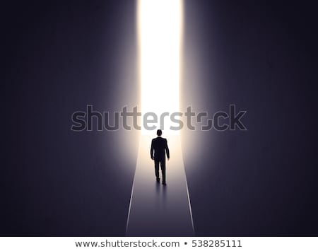 Stock photo: Business Person Looking At Wall With Light Tunnel Opening
