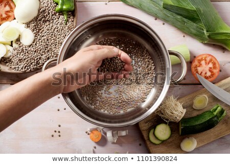 Foto d'archivio: Man Preparing A Vegetarian Lentil Stew