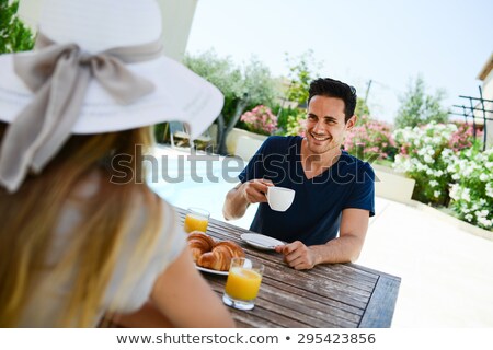 Stockfoto: Two Young Women Having Breakfast In The Garden