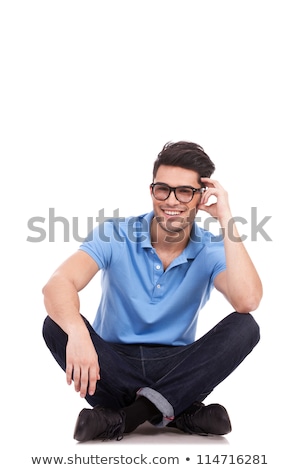 Stock photo: Young Fashion Man Sitting With His Legs Crossed