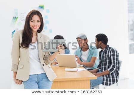 Foto stock: Businesswoman Using Digital Tablet With Colleagues Behind