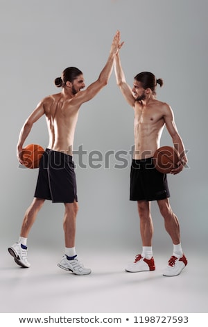 Stok fotoğraf: Portrait Of A Two Smiling Muscular Shirtless Twin Brothers