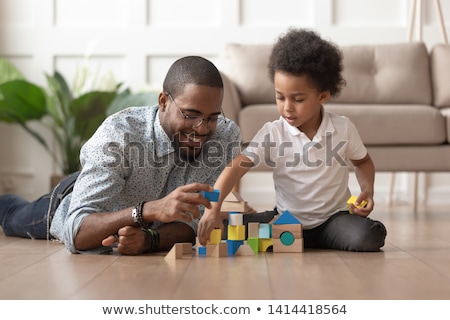 ストックフォト: Father And Baby Playing With Toy Blocks At Home