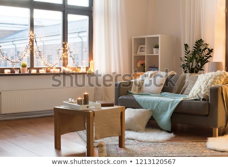 Stock photo: Candles Burning On Window Sill With Garland Lights