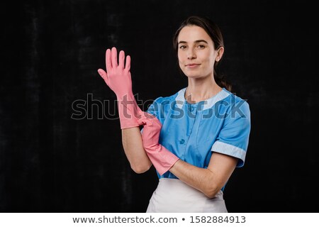 Сток-фото: Pretty Hotel Maid Putting On Pink Rubber Gloves In Front Of Camera