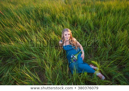 Foto stock: Wonderful Blonde Young Smiling Woman Lying Looking At Camera