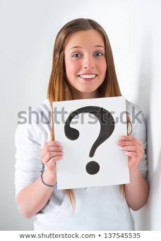 Foto stock: Portrait Of Happy Student With Question Mark Sign At Campus