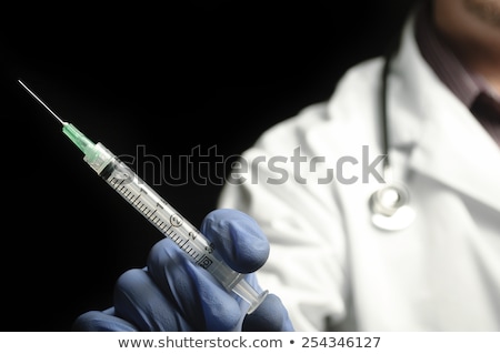 Stok fotoğraf: Male Doctor Holding Syringe With Injection
