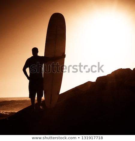 Long Boarder Surfing The Waves At Sunset [[stock_photo]] © homydesign