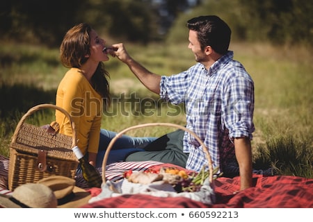 Stockfoto: Couple With Picnic Basket In Field