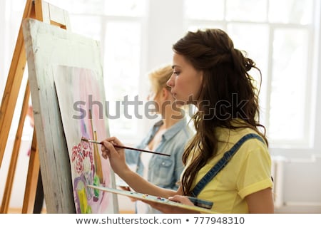 Stockfoto: Woman With Easel Drawing At Art School Studio