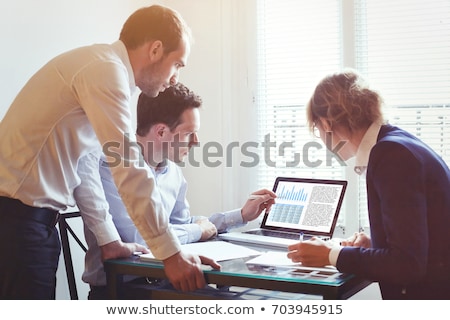 [[stock_photo]]: Discussing Data On Laptop Screen