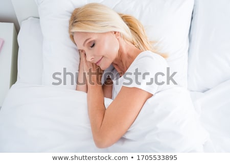 Stock photo: Young Pretty Blond Woman In Bed Covered White Sheets Smiling Che