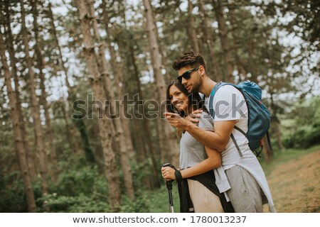 Stok fotoğraf: Smiling Couple With Bags Traveling On Mountains