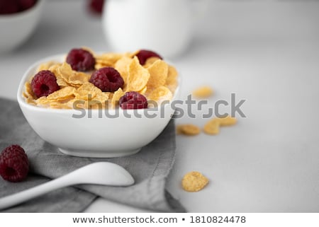 Stock photo: Golden Cornflakes With Fresh Fruits Of Raspberries Blueberries And Pear In Ceramic Bowl