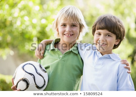 Stockfoto: Two Young Boy Outdoors With Soccer Ball Smiling