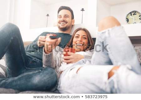 Foto stock: Young Couple Watching Television