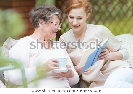 Stock photo: Old Person Reading In The Garden