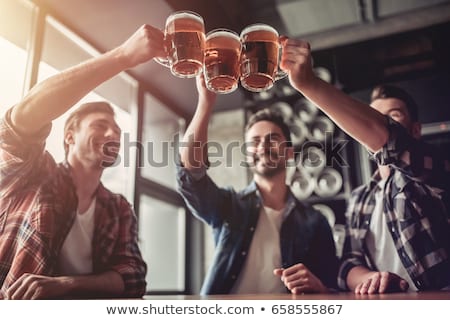 Foto stock: Happy Man Drinking Beer At Bar Or Pub