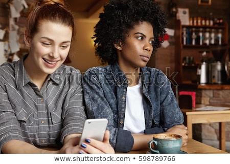 Zdjęcia stock: Jealous Lesbian Woman Looking At Partner Messaging On Social Media