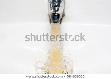 ストックフォト: Dirty Brown Running Water Falling Into A White Sink From Tap Environmental Pollution Concept Banner