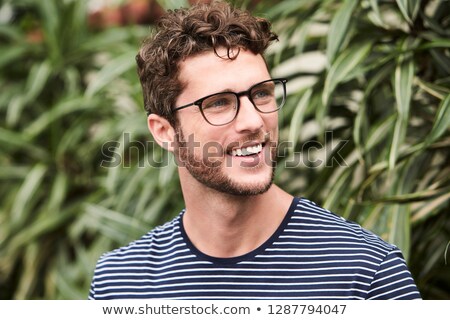 ストックフォト: Young Handsome Man With Smile Looking Away Outdoors Portrait