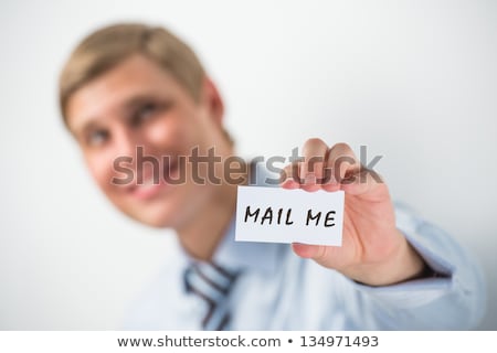 Foto d'archivio: Handsome Businessman Showing Mail Me Text On A Business Card