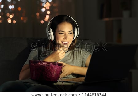 Stockfoto: Young Woman Watching Movie At Home
