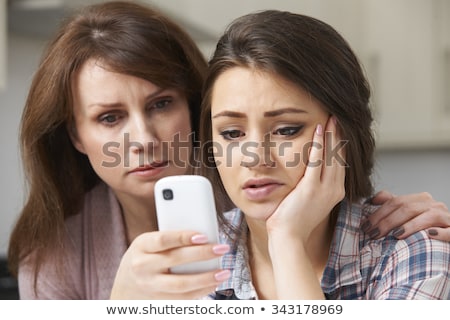 ストックフォト: Mother Comforting Daughter Being Bullied By Text Message