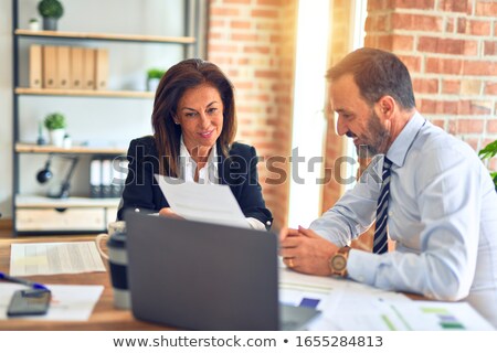 Foto stock: Two Happy Businessmen Working Together Using Laptop On Business Meeting