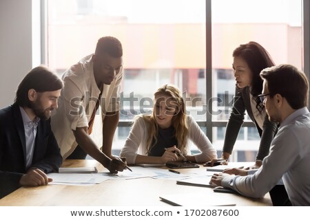 Stockfoto: Group Of Serious Business People Having A Brainstorm Meeting