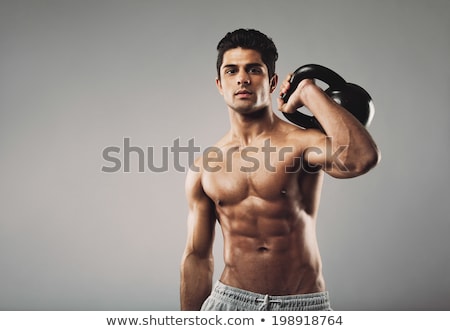 Stok fotoğraf: Male Athlete Weightlifting In Fitness Studio