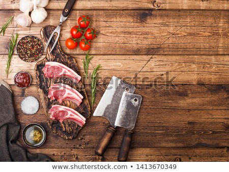 Foto stock: Fresh Raw Butchers Lamb Beef Cutlets On Chopping Board With Vintage Meat Hatchets On Wooden Backgrou