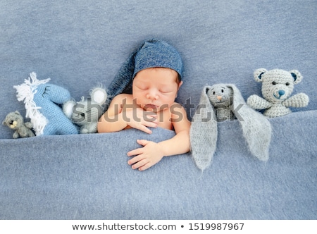 Foto stock: Sweet Baby Girl Lying On Knitted Plush Blanket