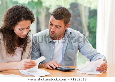 Stock fotó: Stressed Young Couple Calculating Bills Sitting In The Living Room At Home