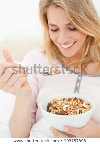 Zdjęcia stock: Cute Woman Eating Cereal In Her Bedroom