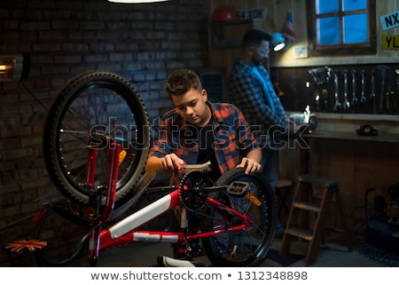 Zdjęcia stock: Father And Son Cleaning Bike Together