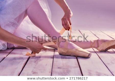 Stockfoto: Professional Ballerina Putting On Her Ballet Shoes