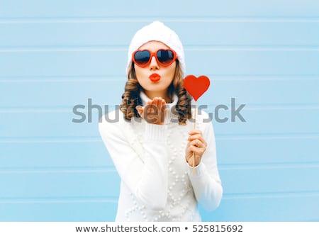 Foto stock: Cute Lovely Woman With Heart Shaped Candy Sending A Kiss