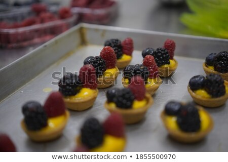 Stok fotoğraf: Raspberry Blueberry And White Chocolate Tart On A White Plate Selective Focus